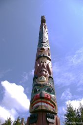 Ketchikan totem pole with spirits white man and animals.jpg