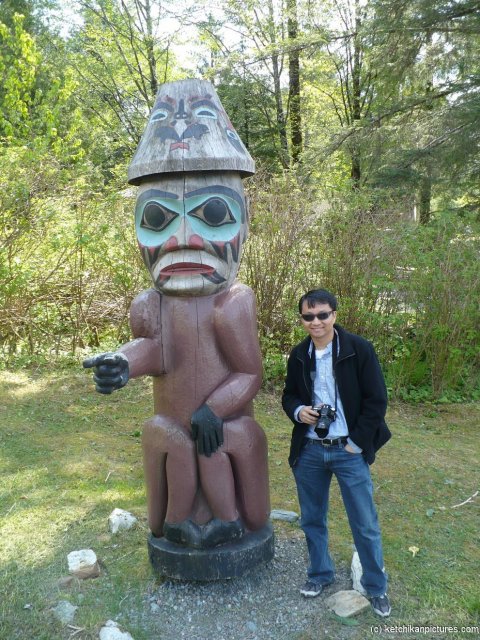 David and a finger pointing totem pole in Ketchikan.jpg
