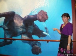 Joann pointing at an elephant mural aboard the Norwegian Pearl.jpg
